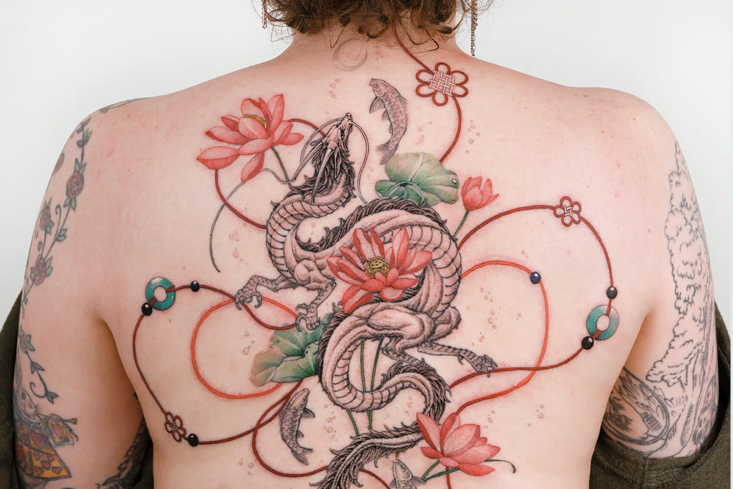 back tattoo with dragon and flowers by sion kwak and intat