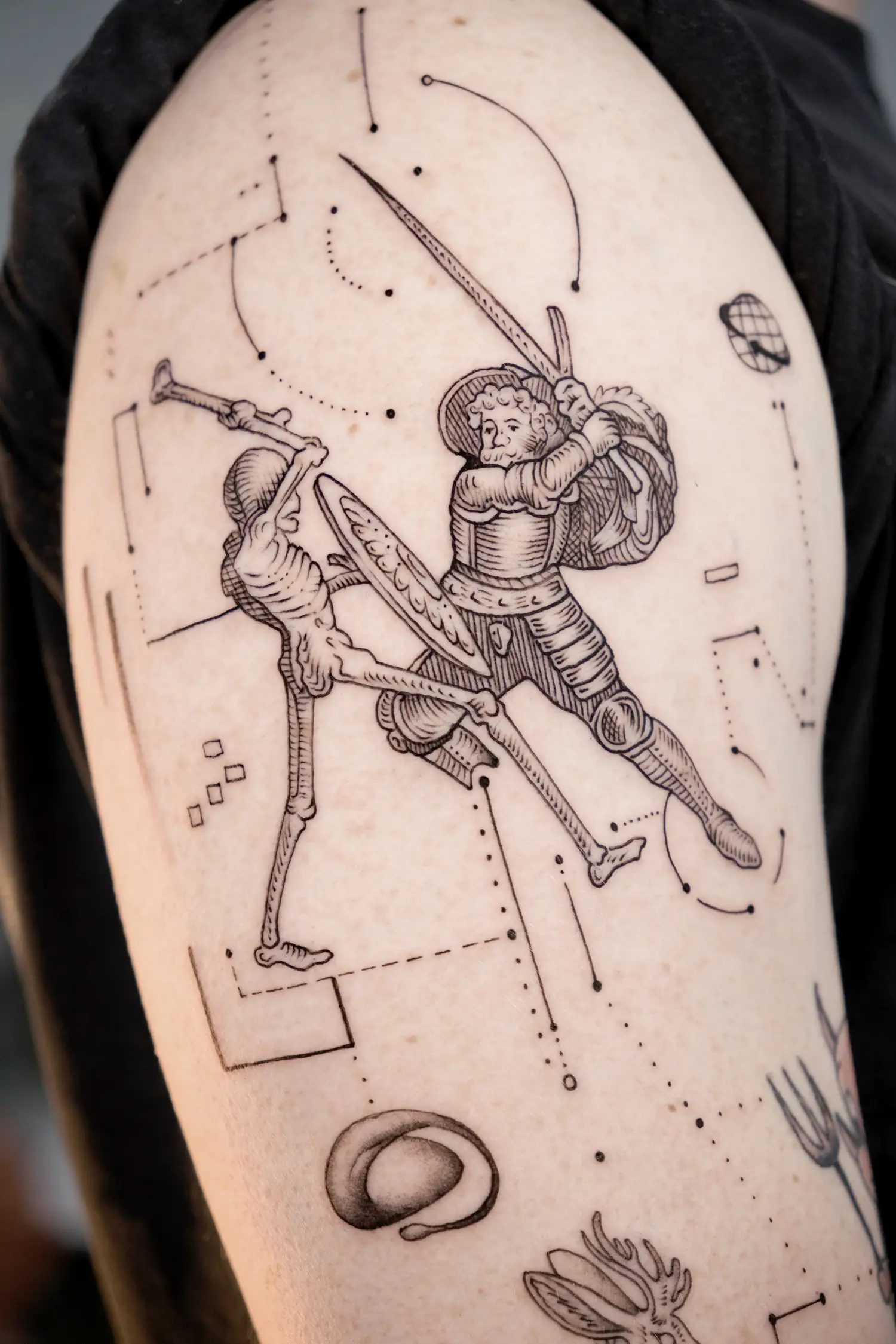 the dance of death battle scene in engraving style tattoo