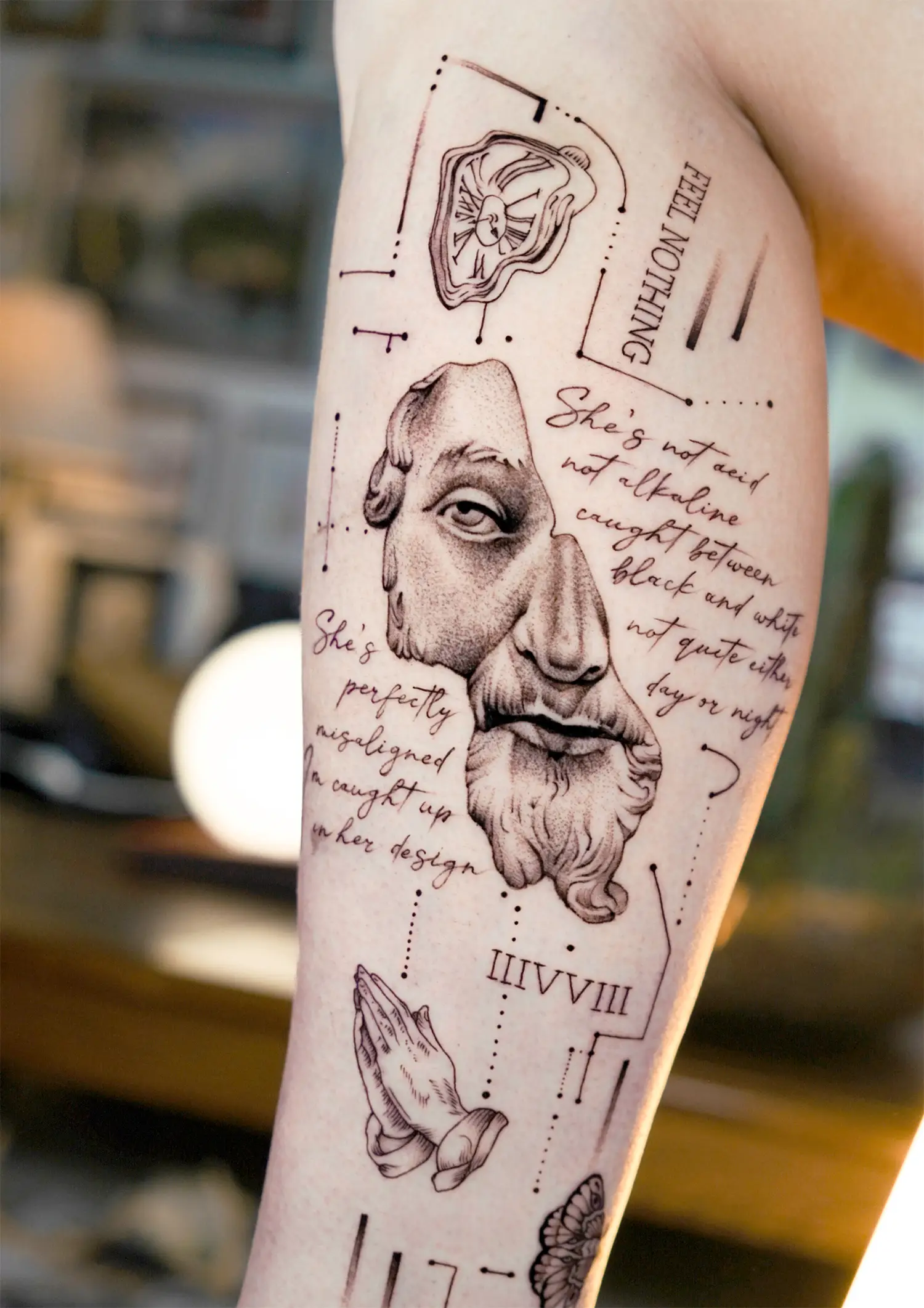 dali melting watch and roman fragmented sculpture and praying hands tattooed