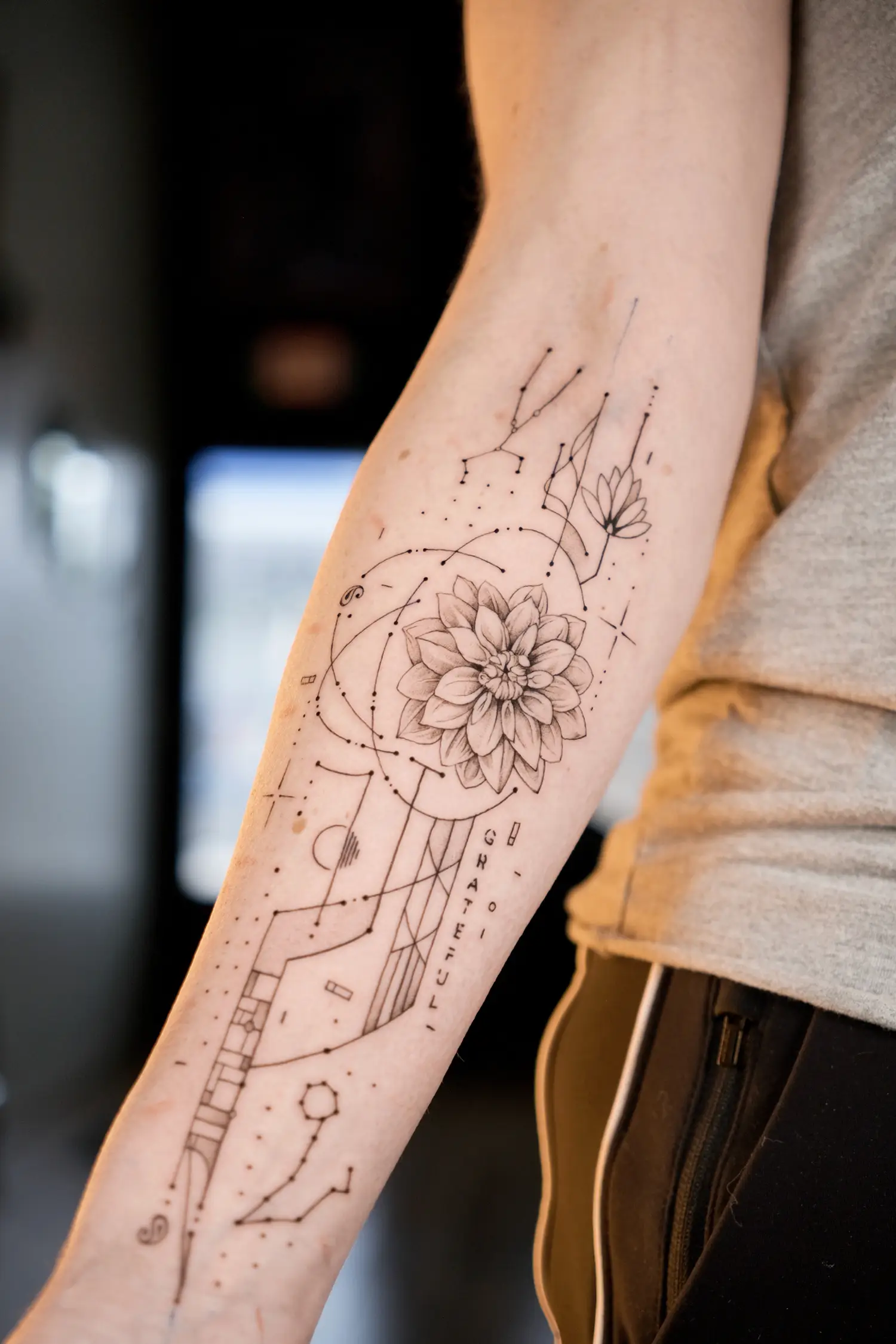 fine line dahlia flow on arm, with architectural lines