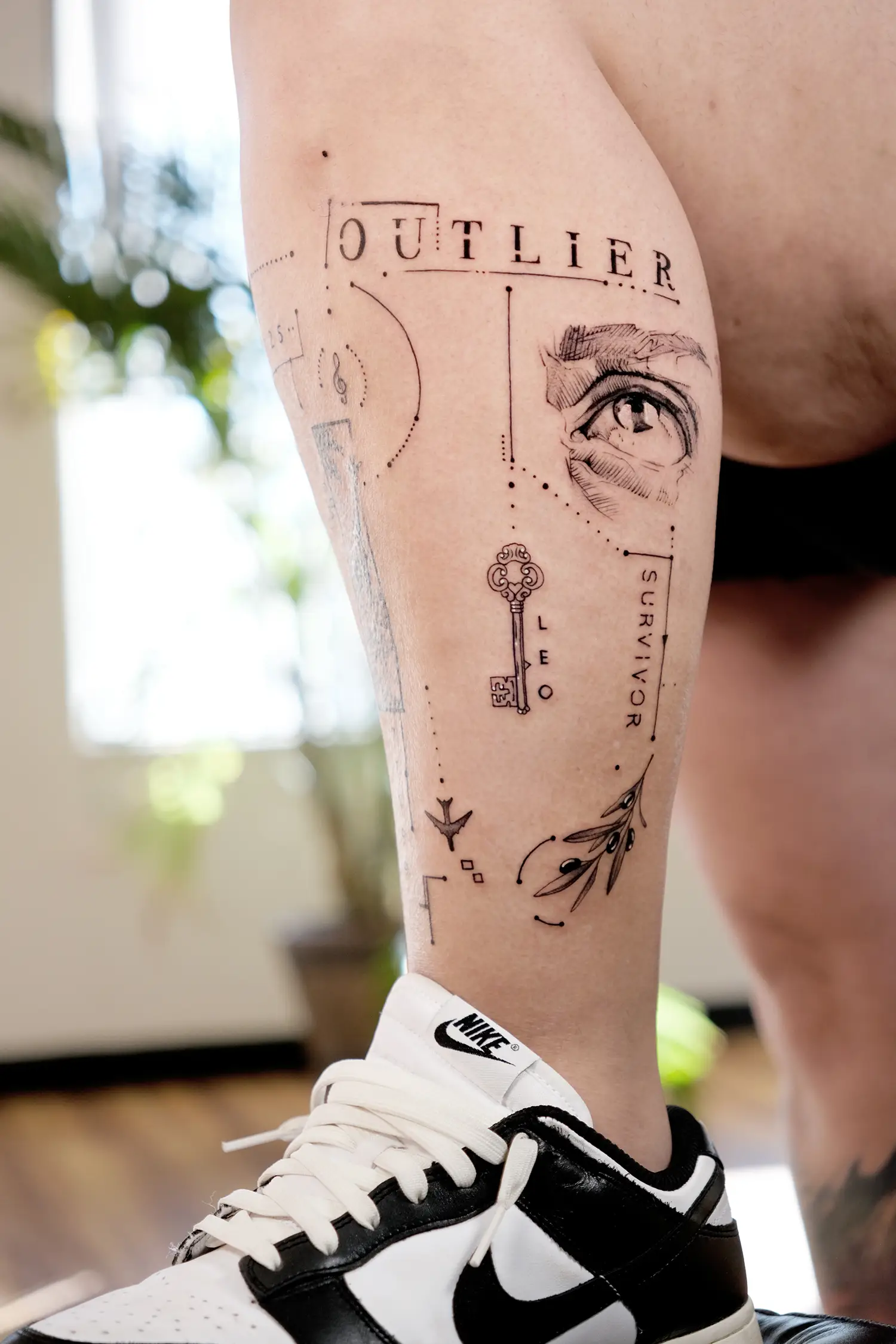 son s name leo and micro tattoo elements on leg