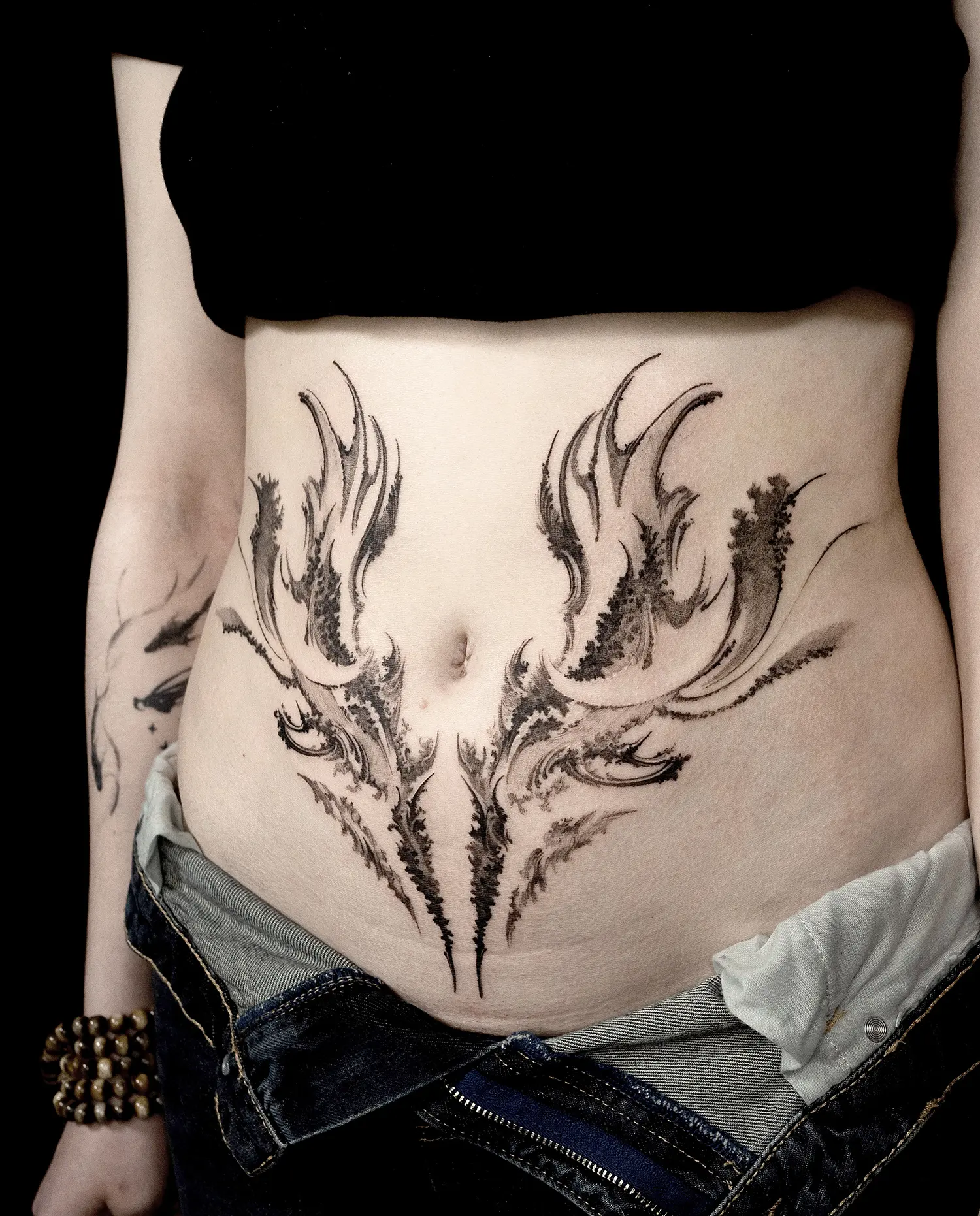abstract tattoo art on stomach
