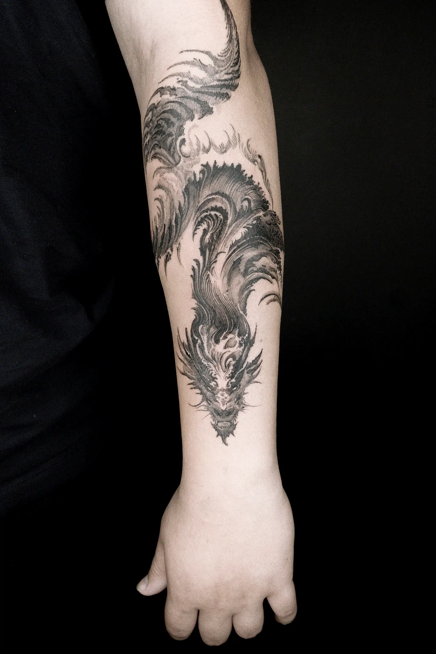 hatching tattoo of dragon on forearm