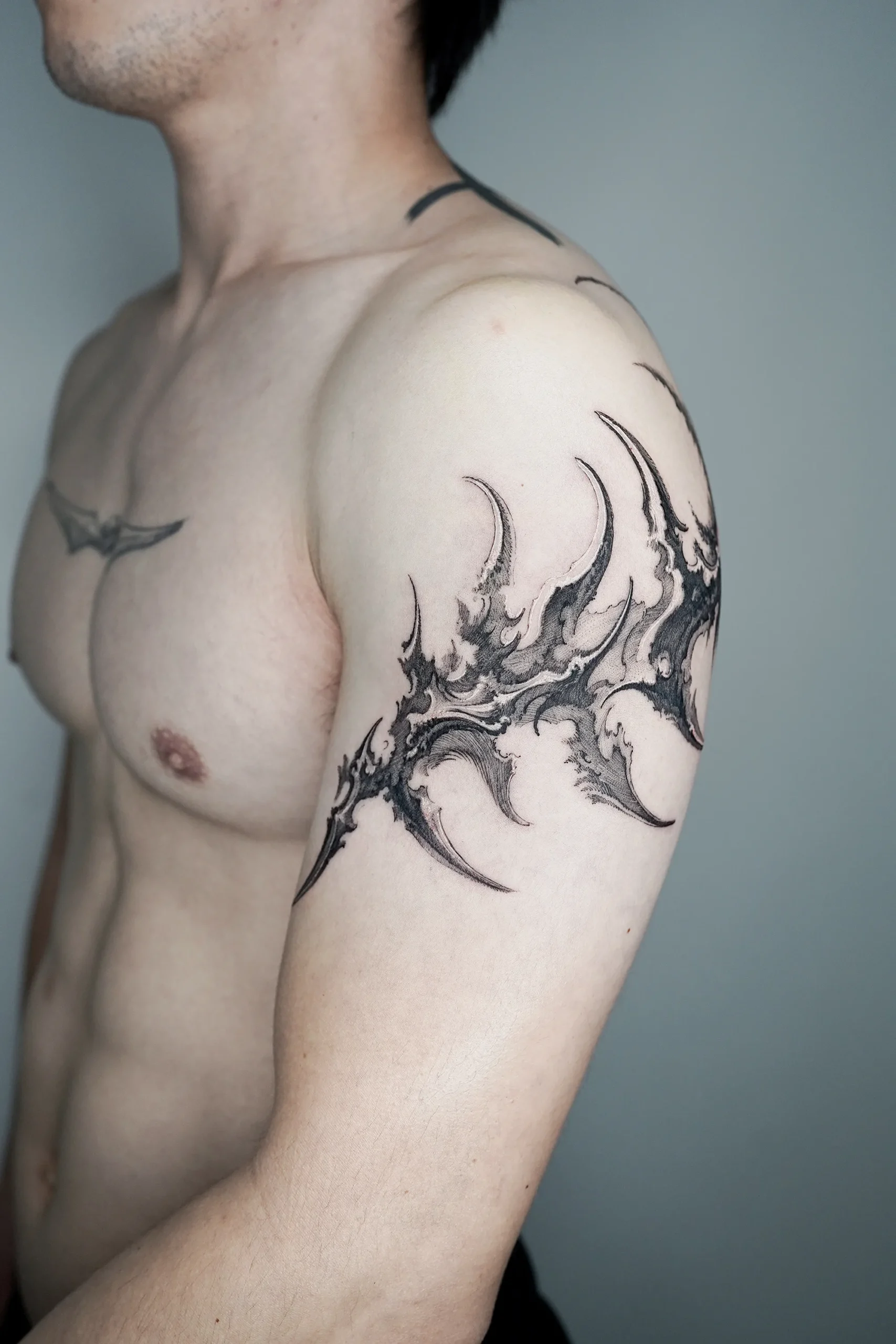 abstract pointy shape art tattoo on arm hatching shading