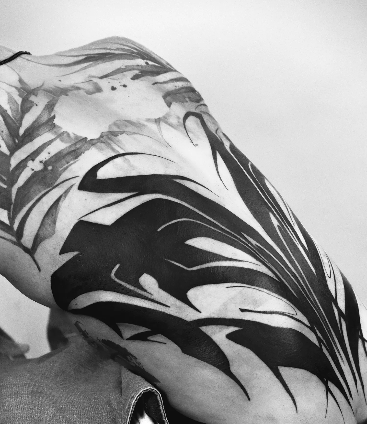 abstract calligraphy and neo tribal tattoo on lower back by ryu