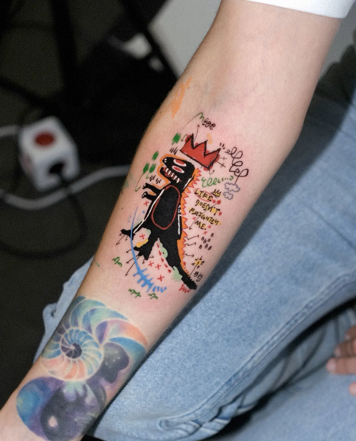 Basquiat TRex, representing strength and vulnerability, has been depicted in tattoo form by XAMO