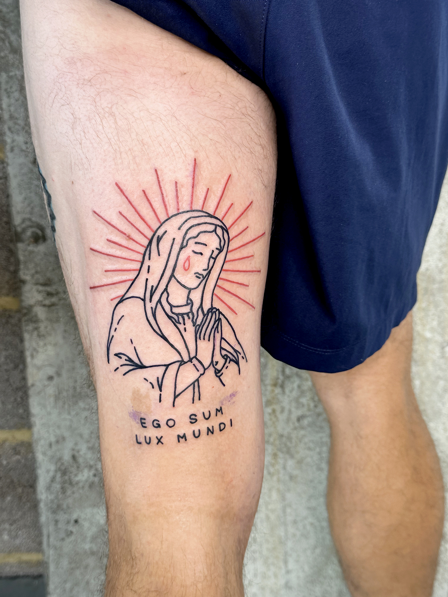 tattoo of the weeping Virgin Mary may reflect on divine sadness for human sin and suffering