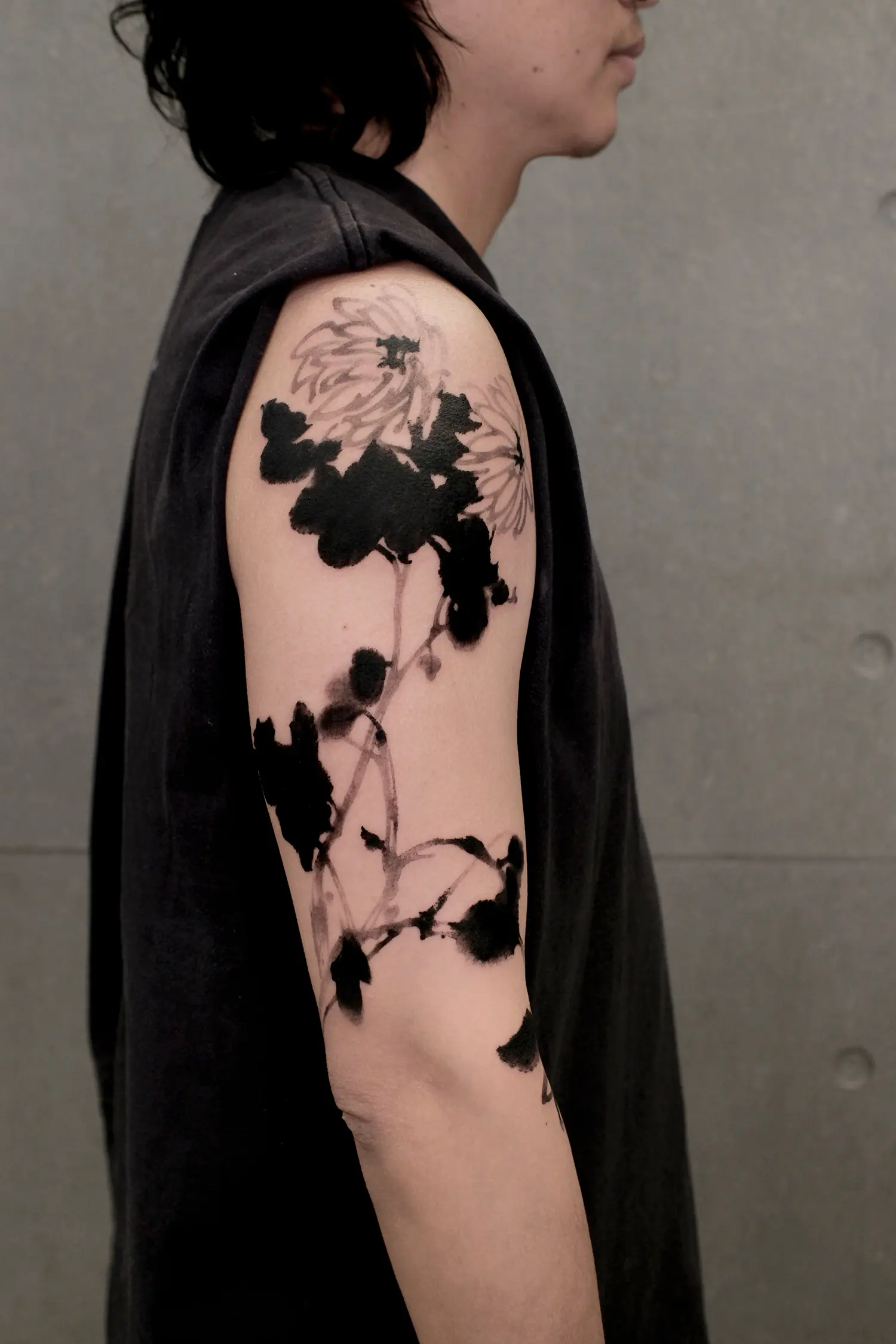 Chrysanthemums are shown minimally, using bold black ink and ink washes