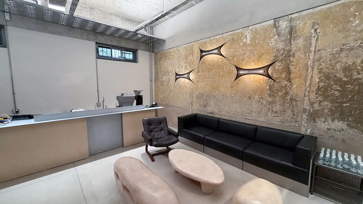 A hypermodern reception area at the NewTattoo Studio in Sanlitun contains marble furniture and a decorative wall