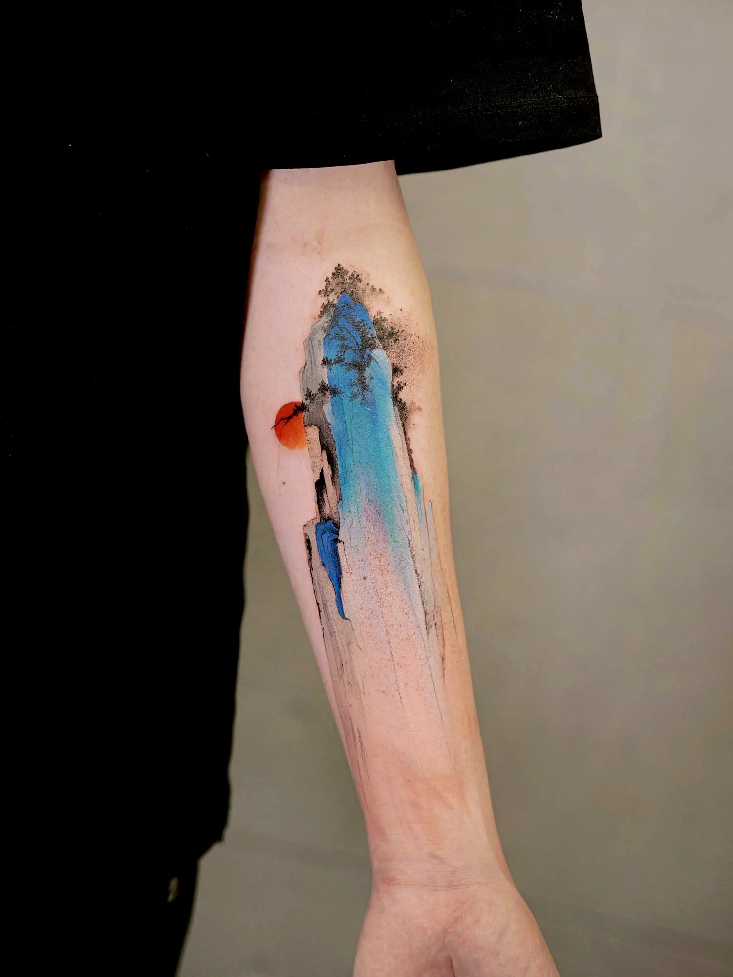 Inspired by Wang Ximeng A Thousand Li of Rivers and Mountains, this piece uses azurite blue and gentle teal to interpret the mineral palette. mountain tattoo on arm