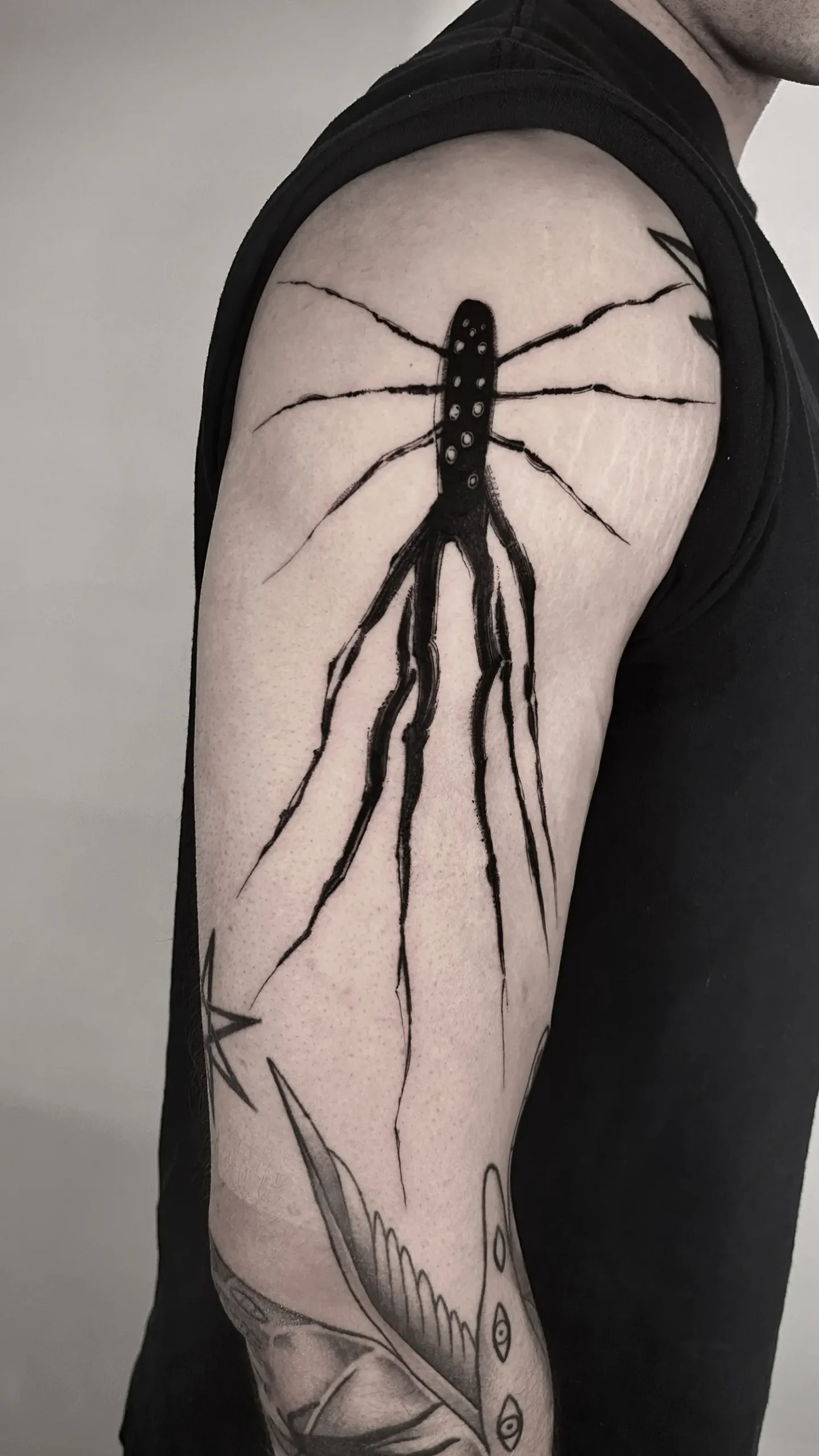 blackwork, octopus character tattoo on arm by Avenn