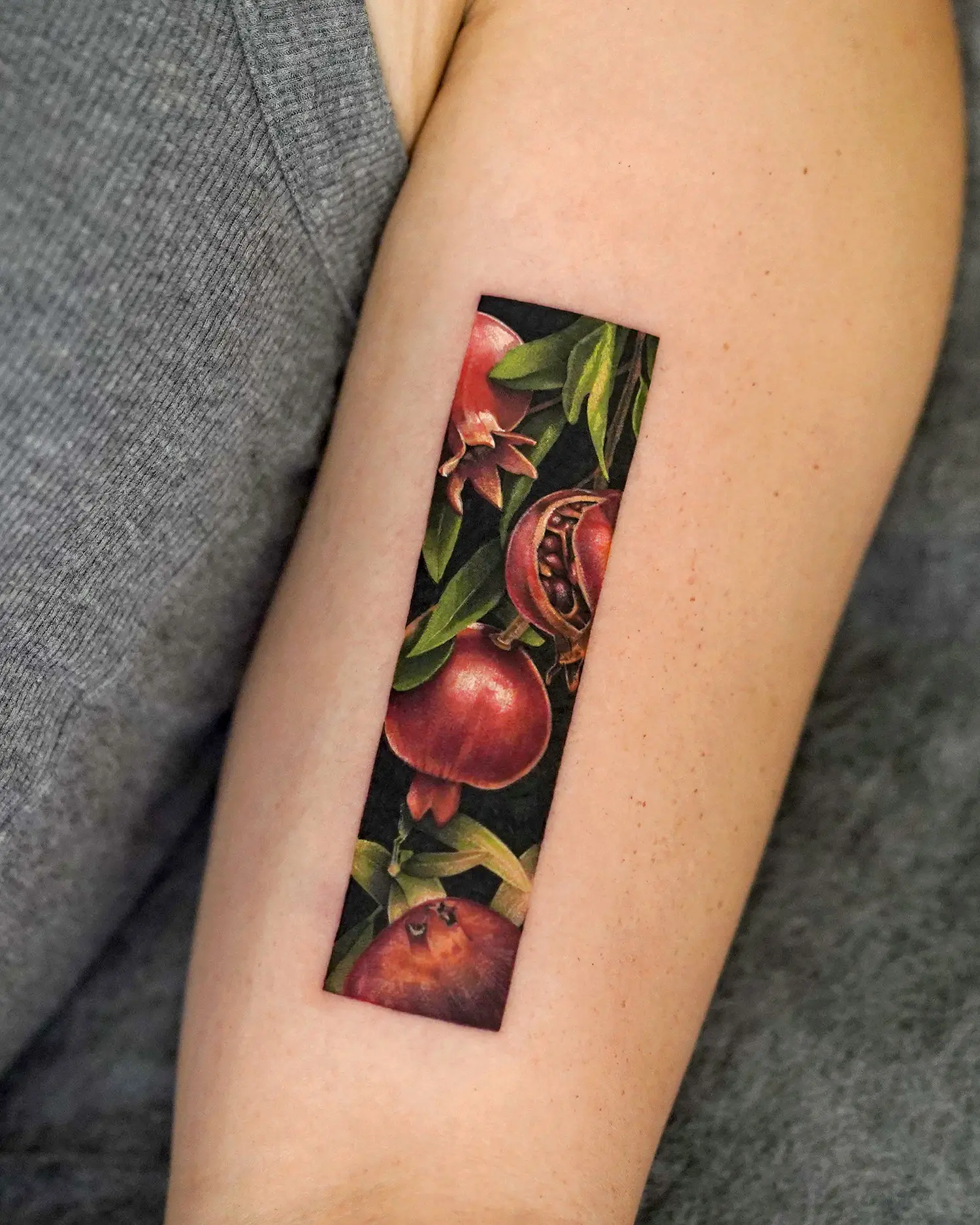 pomegranate tattoo in a rectangle